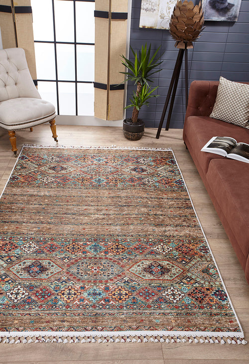Load image 1 in gallery view. A living room features the Tribal Tango - Washable Rug - JR5089 (Custom Size), a brown sofa with an open book, a beige tufted chair, potted plant, large curtained windows, and gray walls with modern decor—perfect for busy spaces.