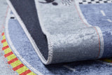 Close-up of the Turbo Tracks - Machine-Washable Rug JRC089 (Custom Size) play mat, featuring blue, yellow, red, and black patterns with roads. Slightly curled to show stitched edges and textured backing; durable flat-weave surface.