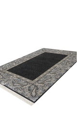 The Turkish Mirage Silk Medallion Rug - Obsidian - 1168D features a rectangular modal silk design with a solid dark center and ornate paisley border in gray, black, and beige, displayed on a white background.