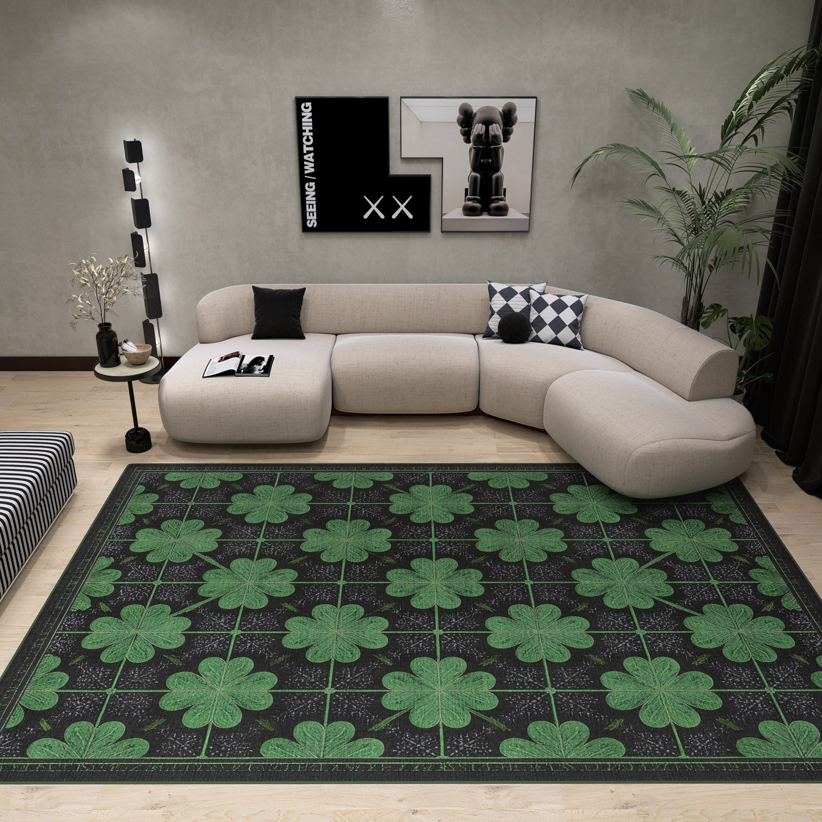 Modern living room featuring the Clover Noir - Washable Rug - JRS012 (Custom Size) with large green four-leaf clovers, ideal for allergy-sensitive and high-traffic spaces. Includes curved beige sofa, black and white pillows, wall art, plants, lamp, and striped ottoman.