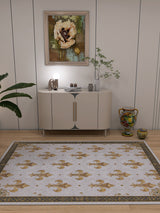 A modern living room with a white cabinet beneath art and decor features the Golden Crest - Washable Rug - JRS015 (Custom Size), allergy-sensitive and ideal for high-traffic areas on light wood floors with elegant gold patterns.