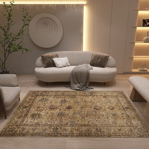 Load image 1 in gallery view. A modern living room features a cream sofa, neutral pillows, and a gray throw. The floor is covered by the Heritage Threads - Washable Rug - JRN1007 (Custom Size), with beige and gold Oriental patterns, complemented by circular wall art and soft lighting.