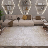A modern living room features a beige sectional, brown accent pillows, wooden tables, geometric shelves with books and decor softly lit, and the Cinnamon Swirl - Washable Rug - JR425 in cream and beige—perfect for high-traffic areas.