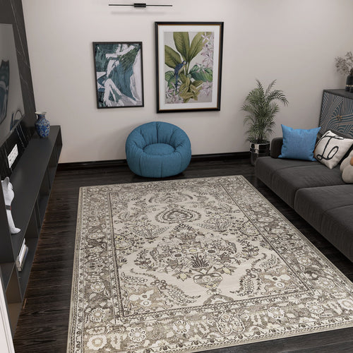 Load image 1 in gallery view. A modern living room featuring the Velvet Mosaic - Washable Rug - JRN1004, a gray sofa with blue pillows, a blue bean bag chair, two framed botanical artworks, potted plants, and a low black media console with decor.