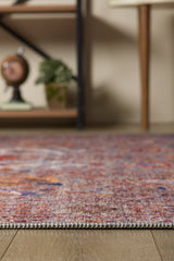 Close-up of the Velorio Floral Washable Rug - LCC3006 (Custom Size) on a wooden floor, with a blurred plant and decor in the background—perfect for high-traffic, allergy-sensitive homes.