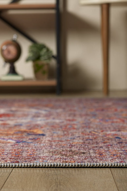 Bild 1 in Galerieansicht laden. Close-up of the Velorio Floral Washable Rug - LCC3006 (Custom Size) on a wooden floor, with a blurred plant and decor in the background—perfect for high-traffic, allergy-sensitive homes.