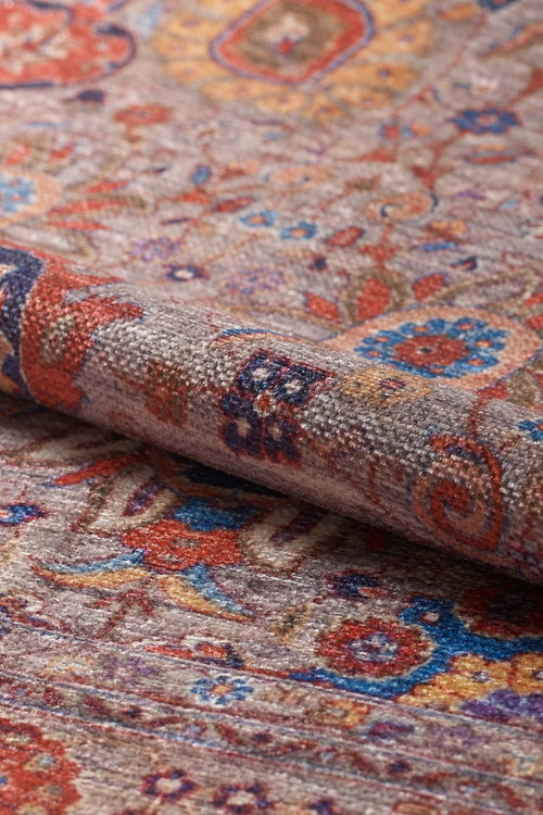 Bild 1 in Galerieansicht laden. A close-up of the Velorio Floral Washable Rug - LCC3006 (Custom Size) shows its intricate floral and geometric patterns in red, blue, orange, and beige. The rug's textured weave is ideal for high-traffic areas and is clearly visible.