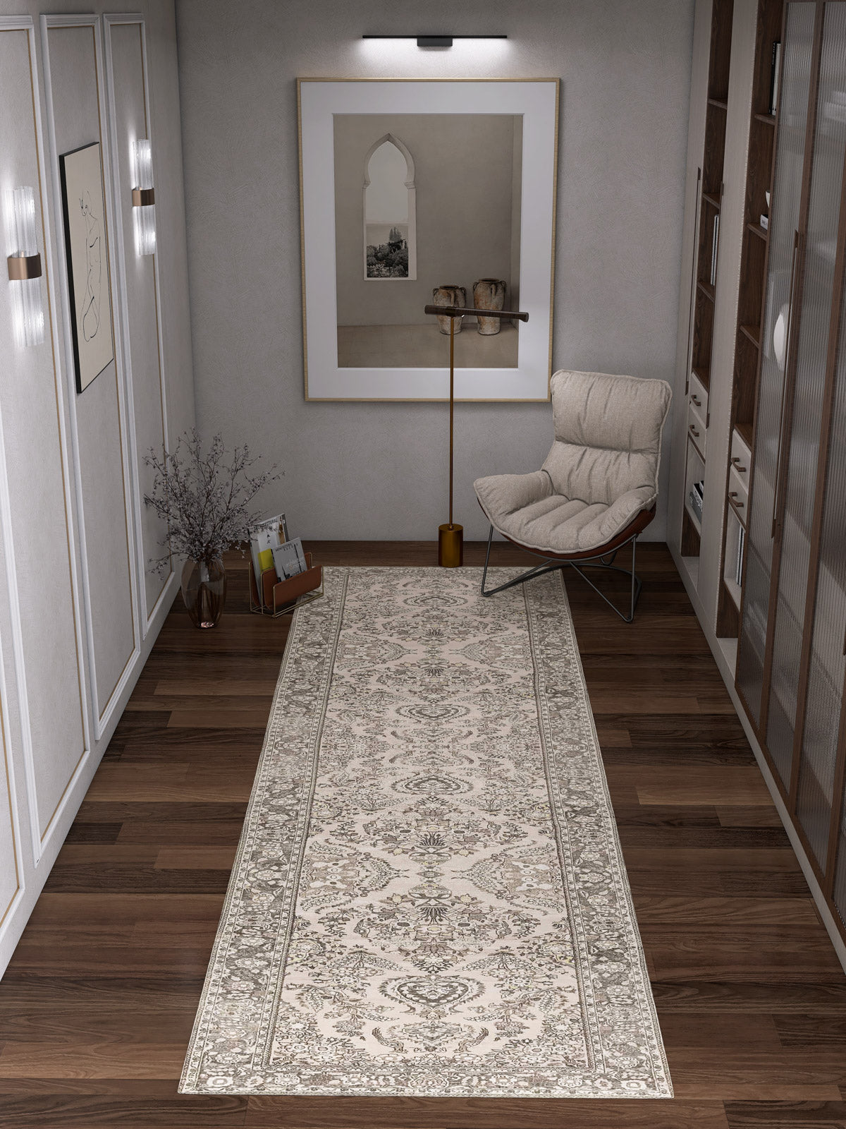 A modern hallway showcases the Velvet Mosaic - Washable Rug - JRN1004 (Custom Size) in cream and beige on wooden floors, paired with a beige lounge chair, brown pillow, floor lamp, arch wall art, shelves, and decorative accents.