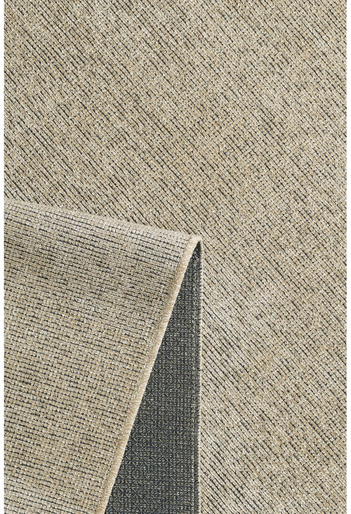 Load image 1 in gallery view. A close-up of the Velvet Touch Beige Area Rug - PST002 shows its textured surface with a subtle grid pattern, and one corner folded to reveal the darker, non-slip backing.