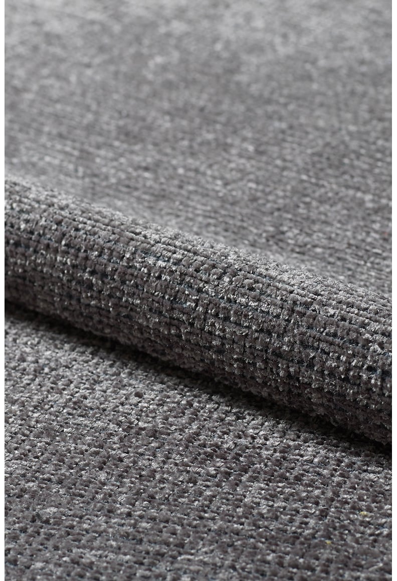Close-up view of Velvet Touch Dark Gray Area Rug - PST005, featuring textured gray fabric with a subtle grid-like pattern, ideal for soft-touch rugs that enhance contemporary decor.