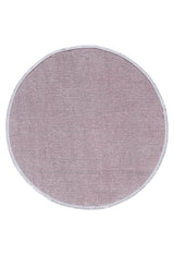 The Velvet Touch Pink Area Rug - PST004 is a round, light mauve rug with a soft-touch feel, subtle textured pattern, and white trim—ideal for adding contemporary style to any space. Shown on a white background.