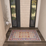 The Navajo Nights - Washable Rug - JR1758 (Custom Size), featuring bold geometric patterns in red, blue, beige, and orange accents, is showcased on dark wood flooring in a stylish entryway—ideal for high-traffic areas.