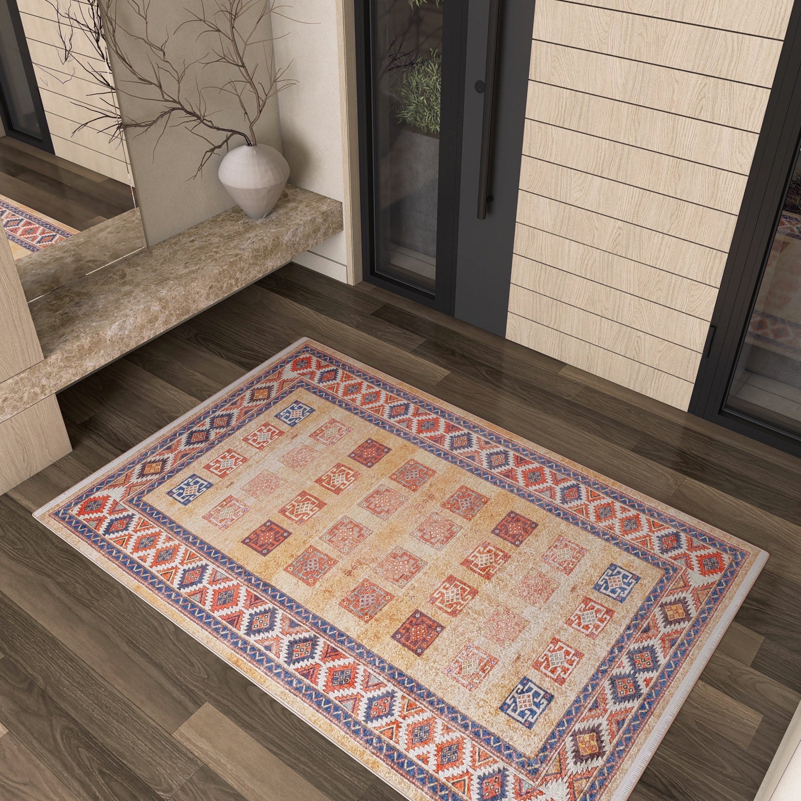 The Navajo Nights - Washable Rug (JR1758), featuring a colorful geometric pattern, lies on a dark wood floor by glass doors. Its durable, washable design and stylish look make it perfect for high-traffic areas.