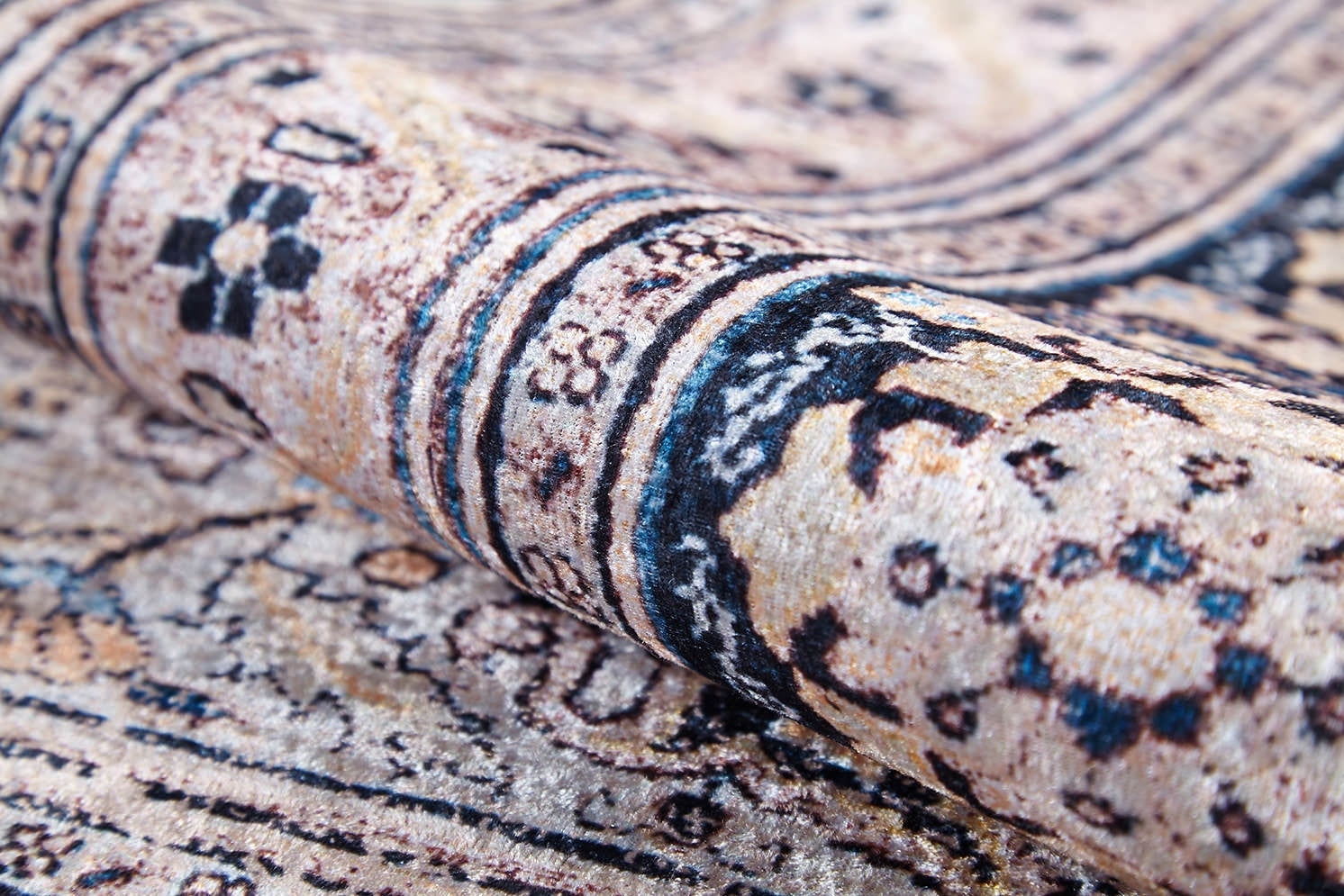 A close-up of the Vintage Charm - Washable Rug - JR1933 (Custom Size) shows detailed beige, black, and blue floral and geometric patterns. Its visible weave and washable design make it perfect for allergy-prone homes or high-traffic areas.