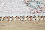 Close-up of the Vintage Cream - Machine-Washable Rug - JR5006 (Custom Size) with white, red, and blue tassels on a light wooden floor. Its subtle pattern and washable design make it ideal for high-traffic areas.