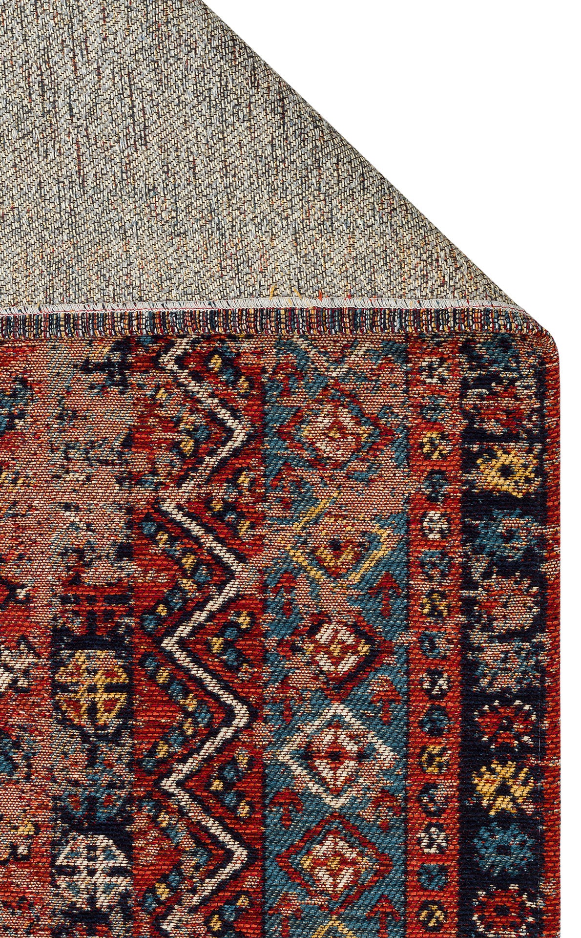 The Vintage Echo - Washable Kilims - AND04 features colorful geometric patterns in red, blue, black, and yellow, with a folded corner that reveals its beige woven underside.