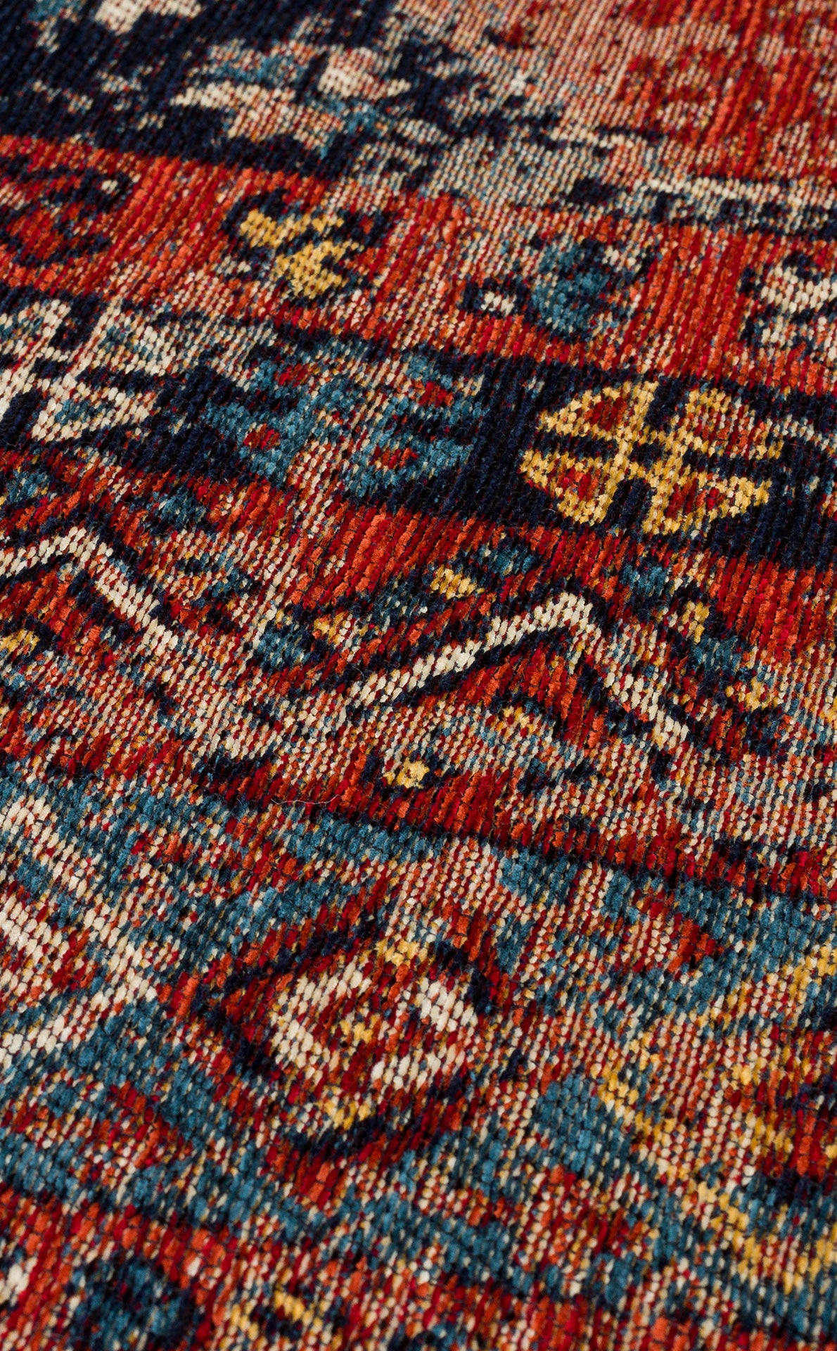 A close-up of the Vintage Echo - Washable Kilims - AND04 rug showcases intricate geometric patterns in red, blue, yellow, and cream with zigzags and symmetrical motifs for a colorful, textured vintage look