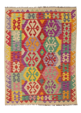 The Vintage Heritage - Handwoven Kilim is a colorful wool rug with geometric patterns, hexagonal motifs, and fringed edges in red, yellow, green, purple, and orange tones—perfect for adding vibrant charm to any space.