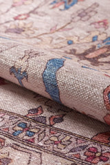 Close-up of the Vivencia Authentic Washable Rug - LCC3016 (Outlet) US in beige, blue, and pink with detailed woven floral designs. A folded cream and beige section highlights the rug’s durability, softness, and thickness.