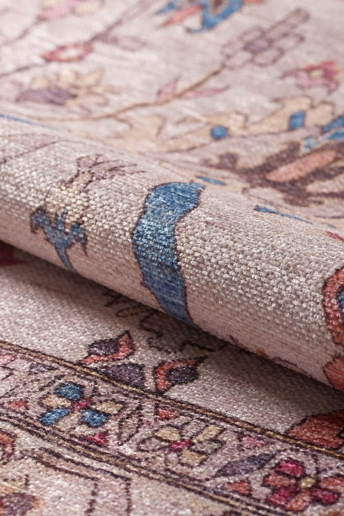 Load image 1 in gallery view. Close-up of the Vivencia Authentic Washable Rug - LCC3016 (Outlet) US in beige, blue, and pink with detailed woven floral designs. A folded cream and beige section highlights the rug’s durability, softness, and thickness.