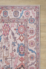 A close-up of the Vivencia Authentic Washable Rug - LCC3016 (Custom Size), featuring geometric and floral patterns in pink, blue, red, and beige on a light wood floor—washable and perfect for allergy-prone homes. Great for cream and beige rug lovers.