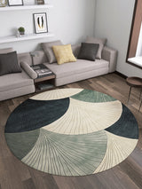 A modern living room with two gray sofas, accent pillows, a small wooden side table, and the Vivian Modern Washable Area Rug - MDJ010 featuring abstract leaf patterns in cream, green, and dark blue—ideal for allergy-prone or high-traffic wood floors.