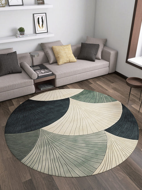 Load image 1 in gallery view. A modern living room featuring two beige sofas, a Vivian Modern Washable Area Rug - MDJ010 (custom size) with a circular abstract pattern in cream, green, and blue, a small round coffee table, and wall shelves with books and decor.