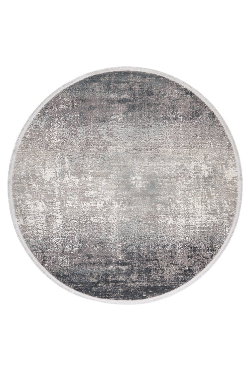 Load image 1 in gallery view. The Vortexia Silver Premium Rug - M472A is a round, machine-made rug with a distressed, textured pattern in gray, white, and black for a modern look in neutral tones.