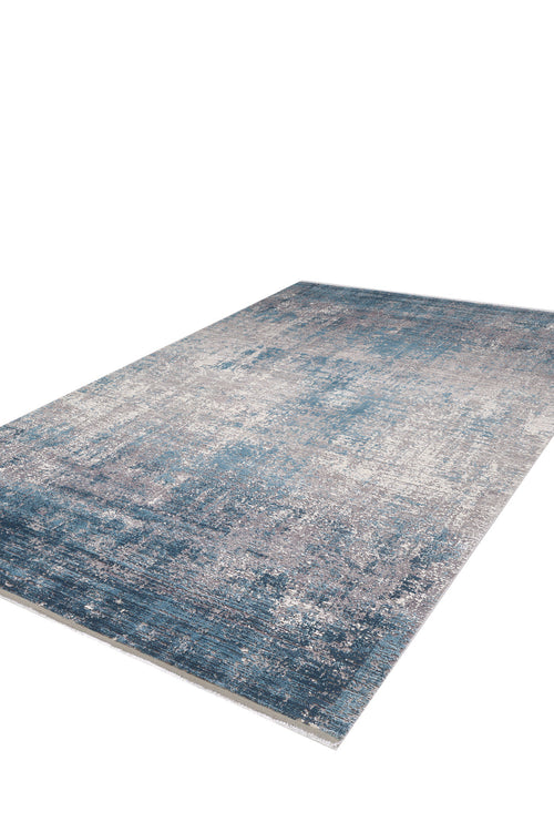 Load image 1 in gallery view. The Vortexia Sky Premium Rug - M472B is a contemporary, machine-made rug with a distressed blue, gray, and white pattern, shown on a white background.