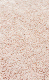 Close-up of the Warm Sand - Washable Shaggy (CBNPLAIN) rug, featuring a soft, fluffy cream beige surface with textured shaggy fibers.