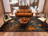 A cozy living room with Halloween decor features the Web Lights - Washable Rug - HLW007 (Custom Size) with orange spiderwebs, pumpkins and moons; a carved pumpkin on the coffee table; a tan sofa with festive pillows; and snowy trees outside.