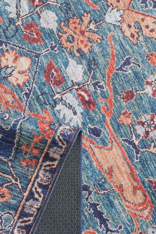 Load image 1 in gallery view. The Whisper Authentic Blue Washable Rug - LCC3034 (Custom Size) features a blue and orange floral pattern, textured dark underside, and intricate border—perfect for high-traffic areas in your home.
