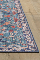 A close-up of the Whisper Authentic Blue Washable Rug - LCC3034 (Custom Size) with a blue border and intricate floral patterns in blue, red, and beige, displayed on a light wood floor—ideal for high-traffic areas.