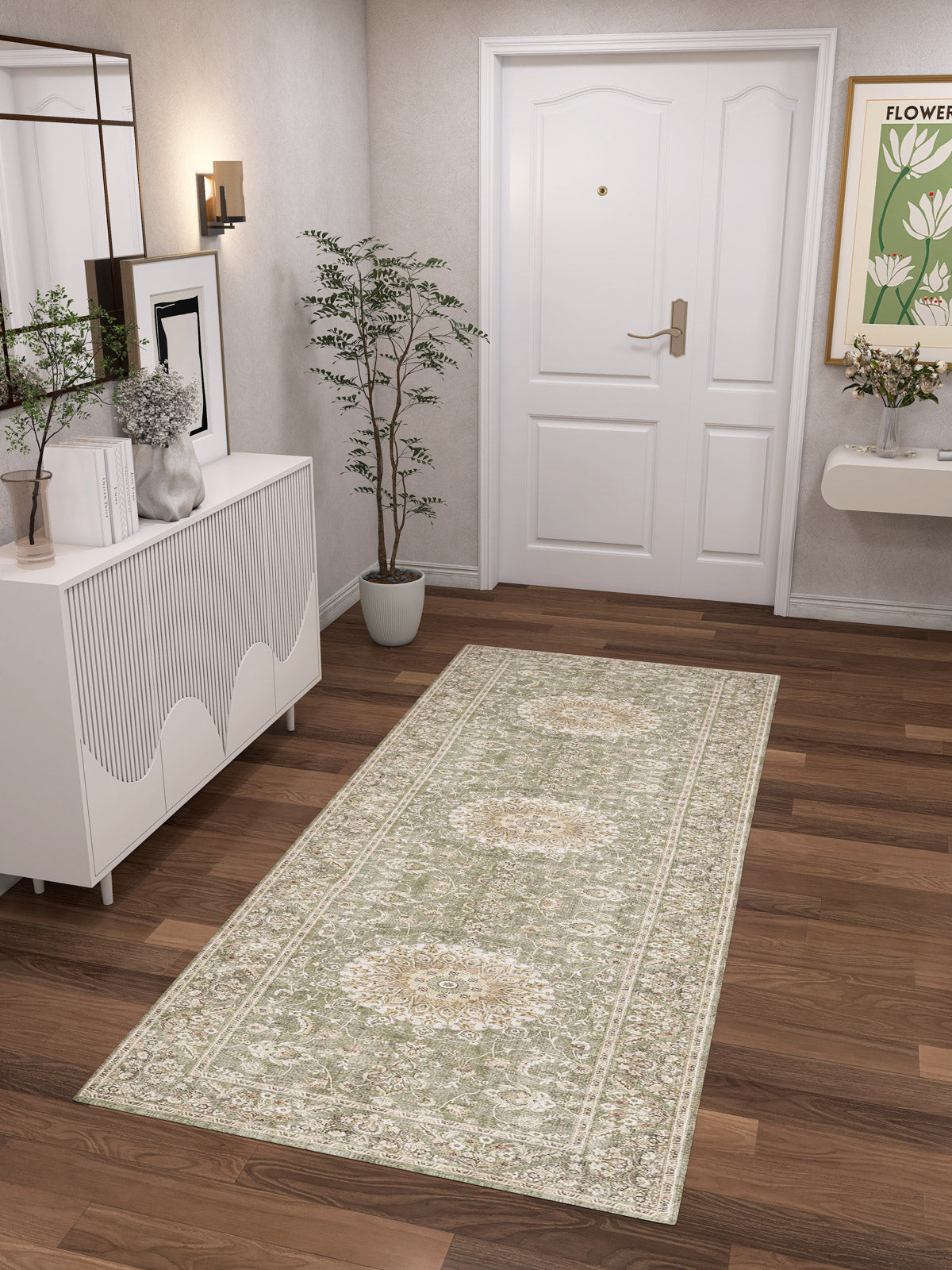 A hallway with a white front door, wooden floor, and the Whispered Heritage - Washable Rug - JRN30 (Custom Size)—a practical pick for high-traffic areas. A white sideboard, decor accents, and wall art complete this clean, inviting entryway.