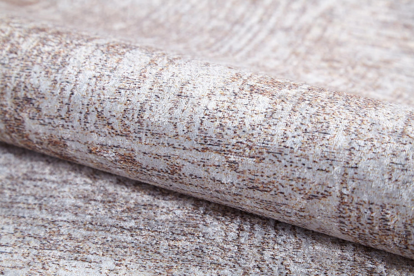 A close-up of the Wildflower Fields - Washable Rug - JR1632 (Custom Size) shows its light beige and brown mottled pattern, subtle woven texture, and a hint of metallic sheen in the flat weave fabric.