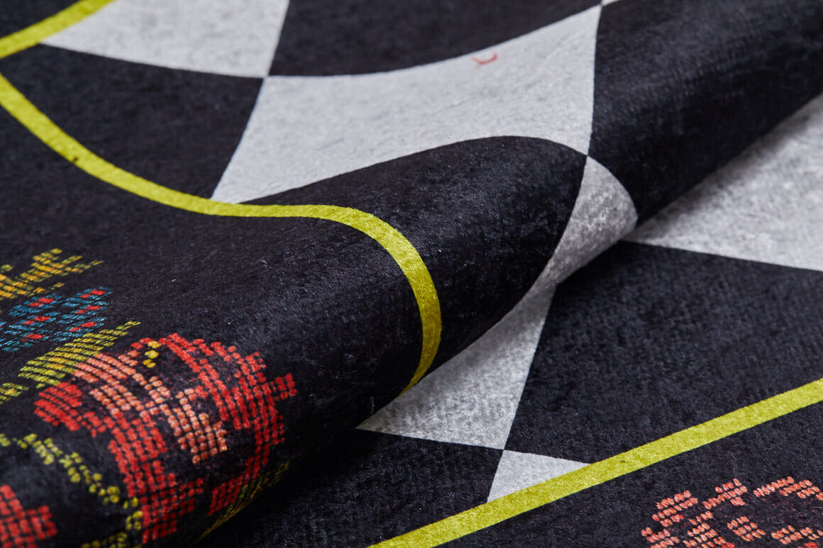 A close-up of the Wildflower Wonderland - Washable Rug (JR587, Custom Size) shows its black and white checkerboard pattern, yellow-green border, and pixelated red floral motifs—durable textured fabric ideal for high-traffic areas.