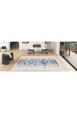 Modern living room with light wooden floors, black armchairs, fireplace, and floor-to-ceiling windows to the patio. The Worn-Out Abstract - Washable Rug - JR339 features blue and white patterns, perfect for allergy-sensitive or busy areas.