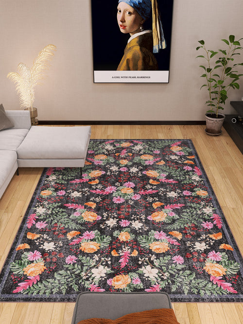Load image 1 in gallery view. A modern living room with a gray sectional sofa, a large Woven Grace - Washable Rug - JRN28 with floral patterns, a potted plant, and a framed print of Girl with a Pearl Earring on the beige wall above the sofa.