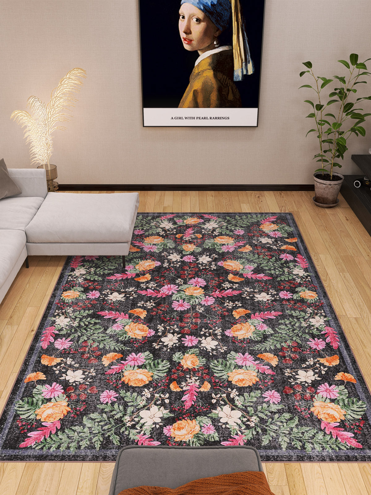 A modern living room with the Woven Grace - Washable Rug - JRN28 (Custom Size), a gray sectional, a potted plant, and a framed Girl with a Pearl Earring print above the sofa. Light wood floors and simple decor complete the look.