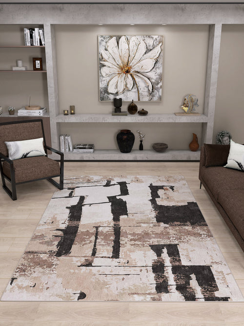 Load image 1 in gallery view. Modern living room with the Woven Memoir - Washable Rug - JRN41 (Custom Size) in beige, black, and taupe—ideal for high-traffic areas—paired with a brown sofa, armchair, sleek shelves with decor, and a striking white floral painting.