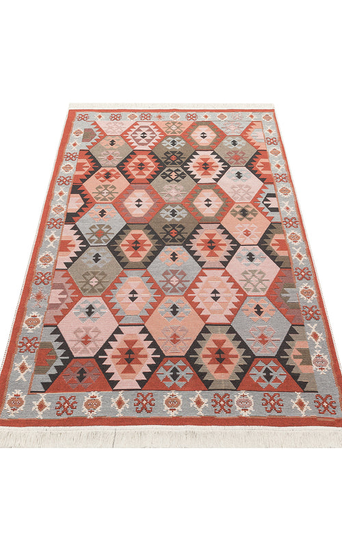 Load image 1 in gallery view. The Woven Spirit - Washable Double-Sided Kilims - AR42 is a rectangular kilim rug with a geometric hexagon pattern in red, orange, gray, and beige. It has a decorative border, fringed edges, and adds both style and versatility to any space.