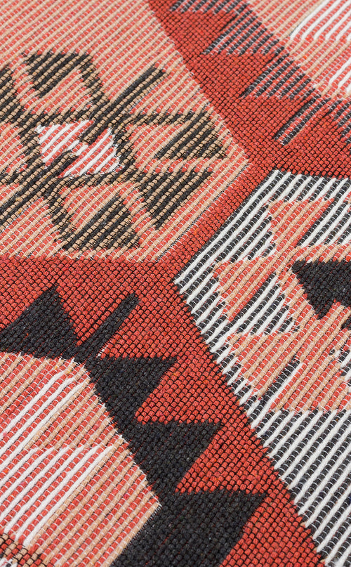 Load image 1 in gallery view. Close-up of the Woven Spirit - Washable Double-Sided Kilims - AR42, highlighting geometric patterns in red, black, white, and tan with intersecting lines, triangles, and diamonds. The textile's fine texture and threads are clearly visible.