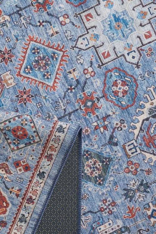 Bild 1 in Galerieansicht laden. A close-up of the Xanadu Handmade-Design Blue Washable Rug (LCC3013) showcases its red, white, and orange geometric floral patterns and textured dark underside—perfect for high-traffic areas and easy cleaning.