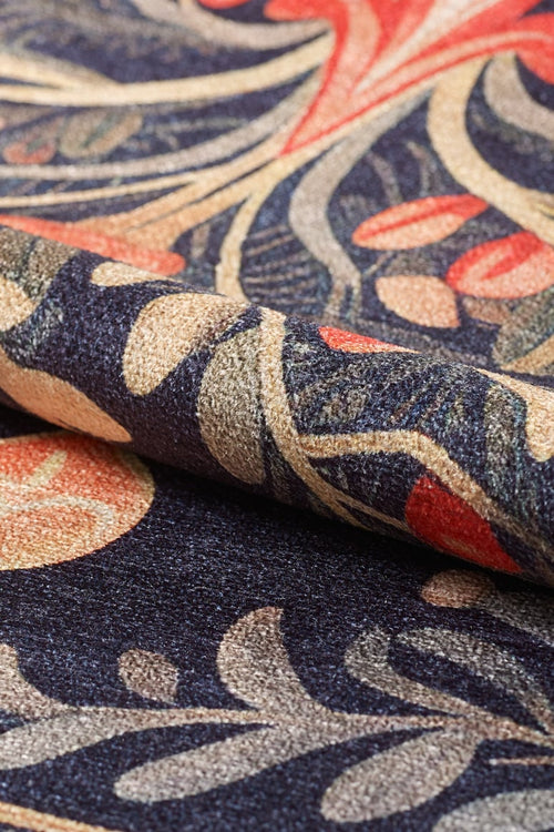 Load image 1 in gallery view. Close-up of the Xmas Tree Washable Area Rug - MDJ005, featuring an intricate, colorful floral pattern in navy blue, gold, beige, and red. The richly woven texture is designed for durability in high-traffic areas.