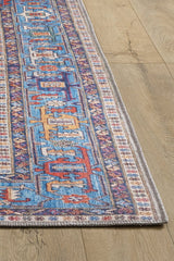 The Yonder Blue Cream Washable Rug (LCC3045) features vibrant multicolor geometric designs with intricate borders and fringed edges. Ideal for high-traffic areas, it sits beautifully on a light wood floor and is easy to clean.