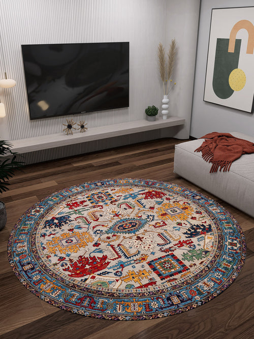 Load image 1 in gallery view. A modern living room showcases the Yonder Blue Cream Washable Rug - LCC3045 (Custom Size), ideal for high-traffic areas, on dark wood floors, paired with a wall-mounted TV, abstract art, a low bench with an orange throw, and decorative plants and vases.