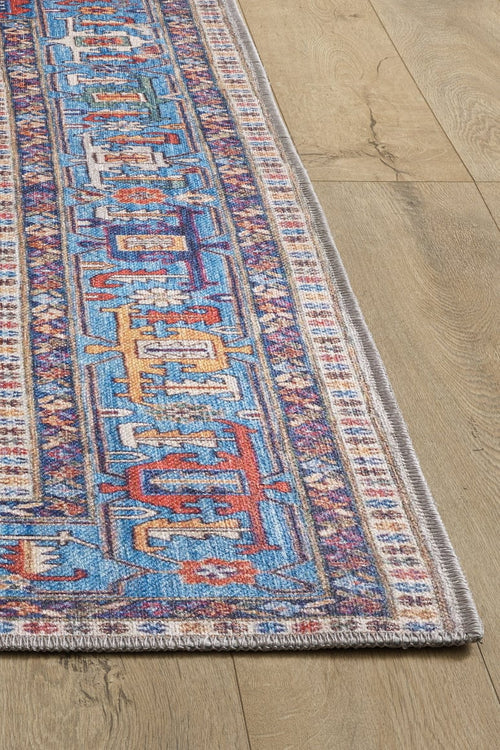 Load image 1 in gallery view. The Yonder Blue Cream Washable Rug - LCC3045 (Custom Size) features vibrant geometric patterns in blue, red, yellow, and ivory with a detailed border—perfect for any space. Its washable design makes it as practical as it is stylish.