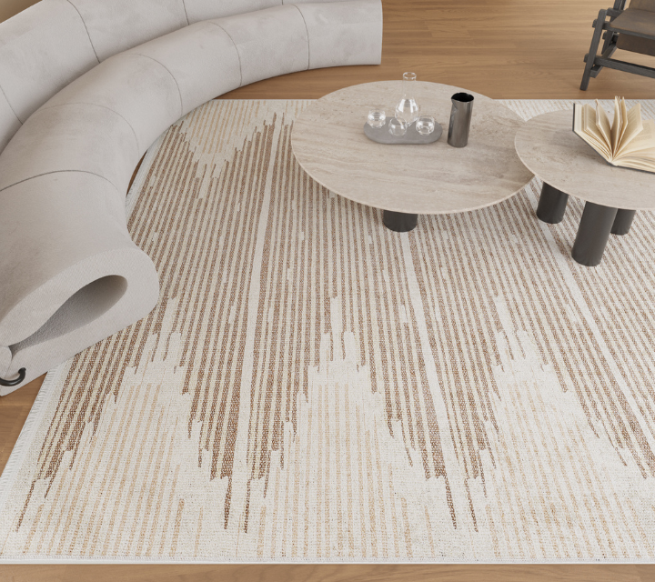 A modern living room features a light beige curved sofa, two round stone coffee tables with books and glassware, and a patterned rug with beige and cream zigzag lines on a wooden floor.