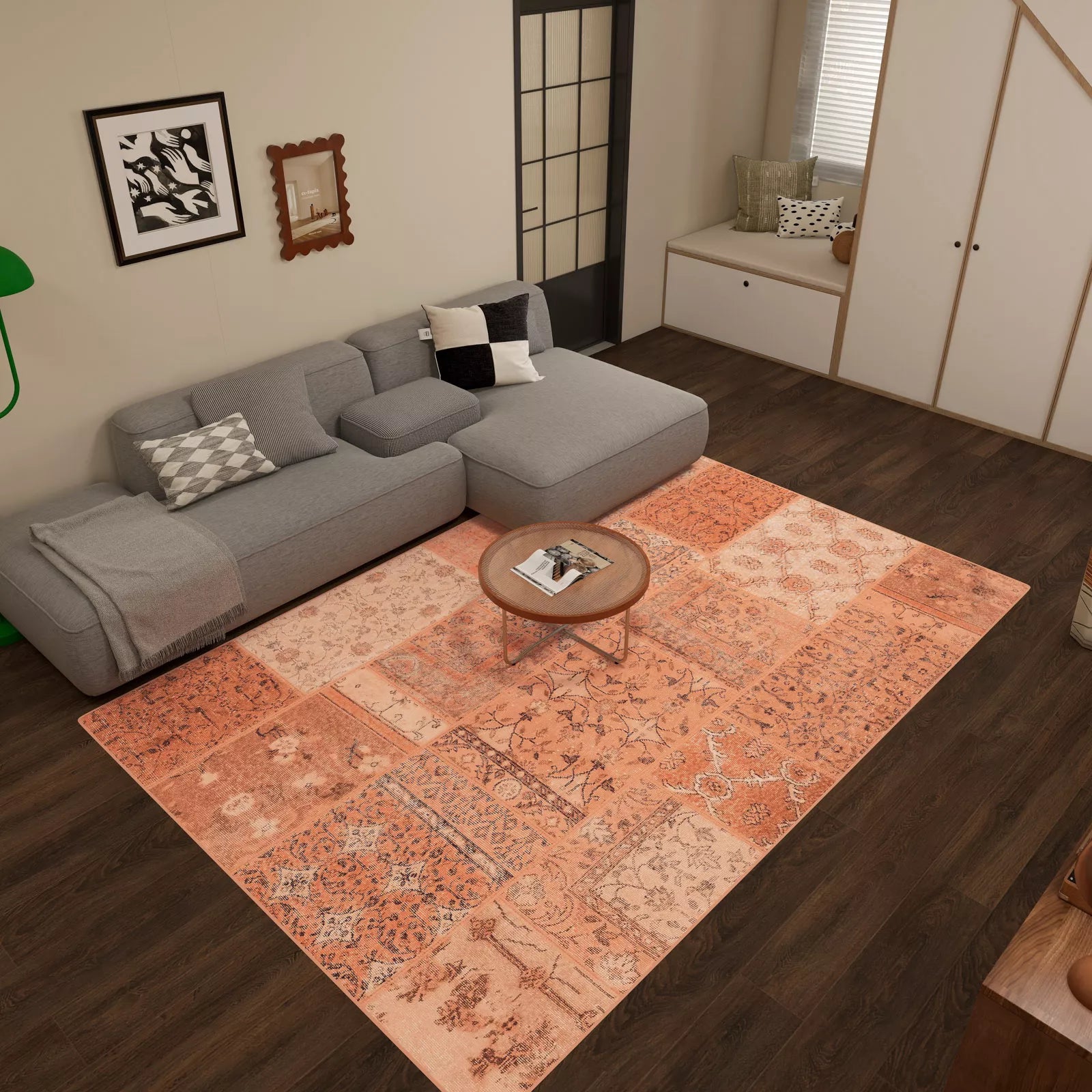 Living room with a gray sofa, patterned rug, and wooden coffee table.