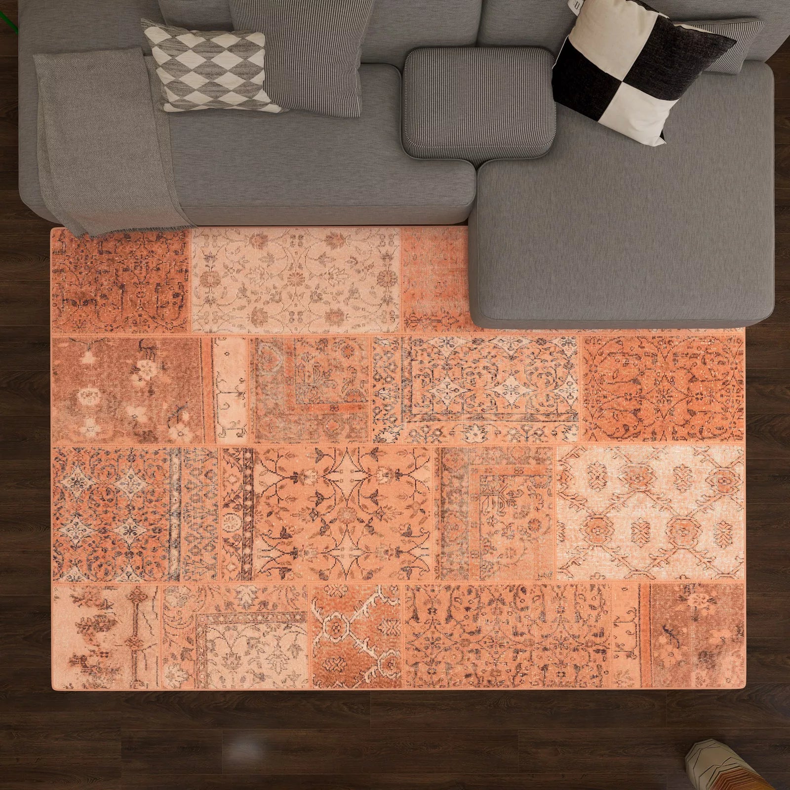 Patchwork area rug in a living room setting with a gray sofa.
